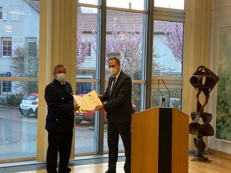 Landrat Dietmar Seefeldt (rechts) zeichnet Klaus Michel mit dem goldenen Feuerwehr-Ehrenzeichen am Bande aus.